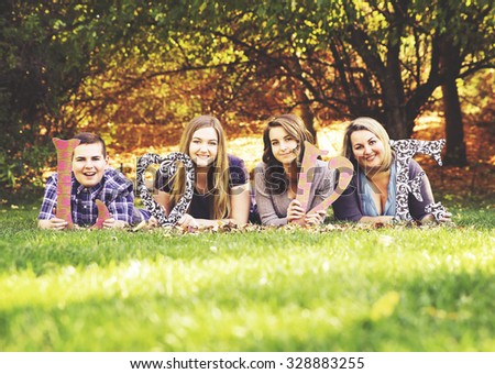 a cute family posing in a park toned with a retro vintage instagram filter effect app or action
