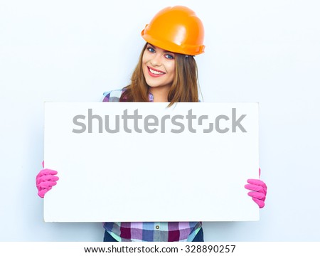 Woman worker builder hold big sign board against white background. Building helmet. Pink glow.