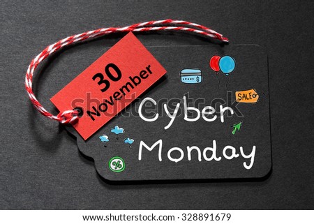 Cyber Monday November 30 text on a black tag with a red and white twine