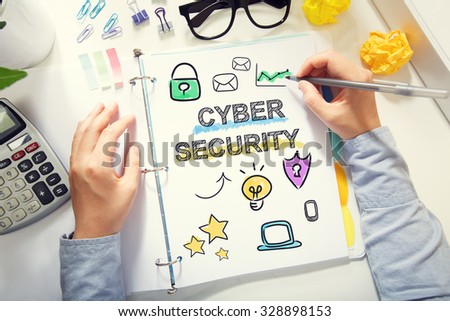 Person drawing Cyber Security concept on white paper in the office