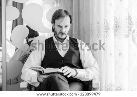 Black and white portrait of reading man,