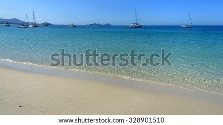 sunny moorings white sandy beach Whitsundays
