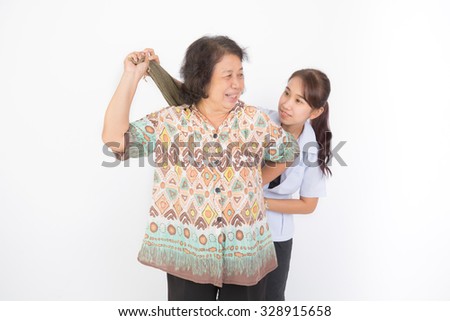 Nurse helping senior stretching capsule of shoulderon white background