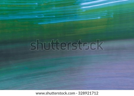 Abstraction of forest at autumn. Colorful background photographed with long exposure and motion effect.