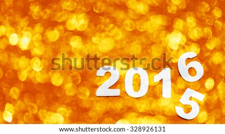 Number with 2016 on orange 
bokeh background, new year template