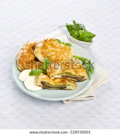 snack cakes with mozzarella and basil pesto on a blue tablecloth dish Gollub