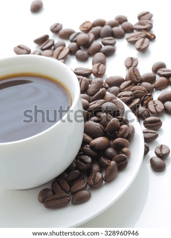 White cup of coffee and coffee beans on a white background