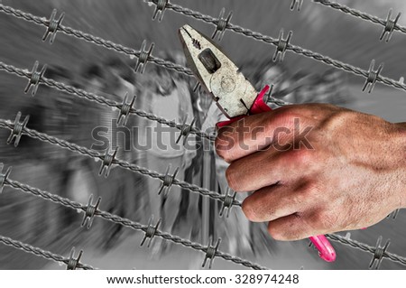 Migrants and barb wire with pliers