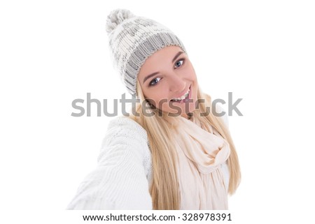 beautiful blond woman in winter clothes taking selfie photo isolated on white background