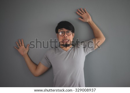 Asian man being pushed to the wall.