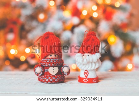 Little cute gnomes at christmas tree background