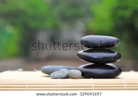 Pebble stones on nature bokeh background - SPA Concept