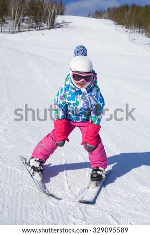 little girl learning to ski at the ski resort