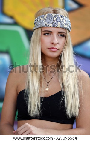 Young woman on painted wall background