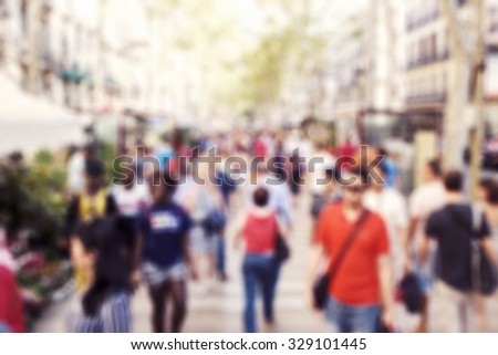 defocused blur background of people walking in a busy pedestrian street