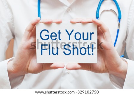 Get Your Flu Shot ! card in hands of Medical Doctor Royalty-Free Stock Photo #329102750