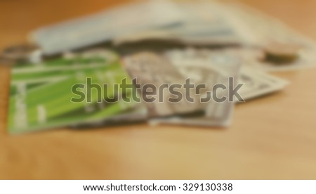 Blurred defocused background photo with money, bank cards and coins