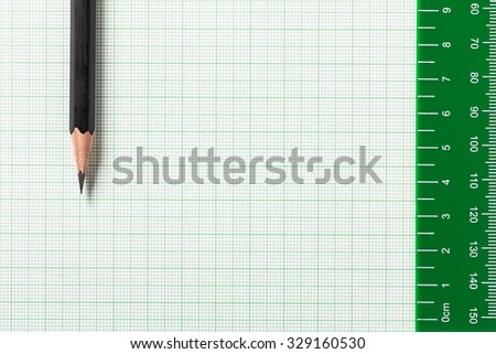 Pencil and Ruler on green graph paper with copy space