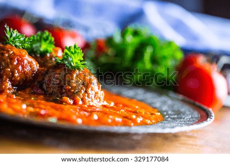 Meat balls with tomato sauce.