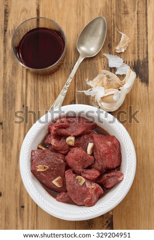 marinated meat with red wine, garlic and spoon