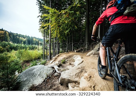Mountain biker riding on bike in autumn inspirational mountains landscape. Man cycling MTB on enduro trail track. Sport fitness motivation and inspiration. Royalty-Free Stock Photo #329224340
