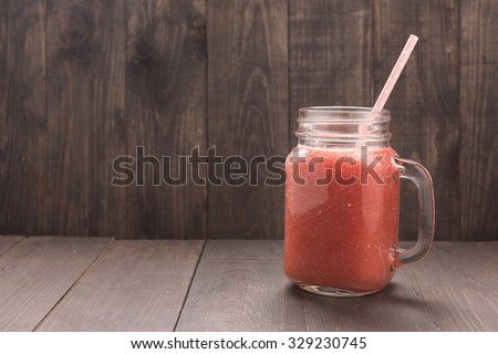 Healthy vegetable. Glass of red tomato juice on wooden table.
