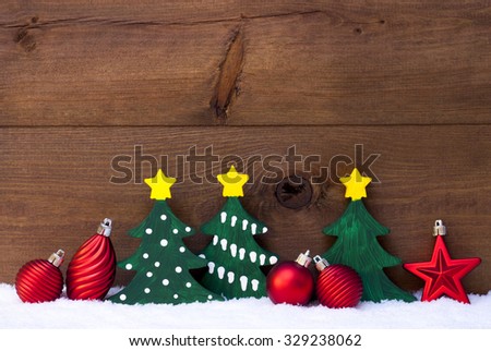 Christmas Decoration On White Snow. Green Christmas Tree And Red Christmas Balls. Brown, Rustic, Vintage Wooden Background For Copy Space. Christmas Card With Snowy Atmosphere