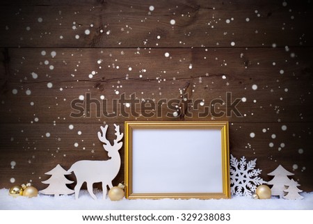 Christmas Card With Picture Frame On White Snow. Copy Space For Advertisement. White Christmas Decoration Like Snowflakes, Tree, Golden Balls And Reindeer. Vintage, Wooden Background By Night