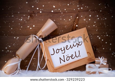 Christmas Card With Picture Frame On White Snow, Snowflakes And Christmas Gifts Or Presents. French Text Joyeux Noel Means Merry Christmas. Christmas Decoration Infront Of Wooden Background