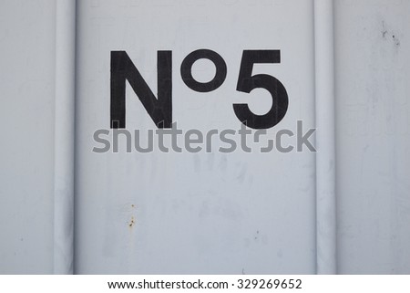 number 5 wroten in black on a white container door Royalty-Free Stock Photo #329269652