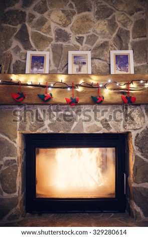 Fireplace with christmas decorations and a light chain