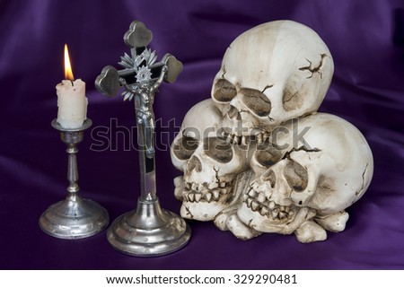Crucifix and weathered human skull - Halloween background