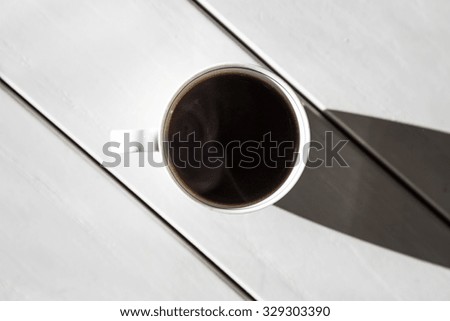coffee cup on white table with shadow