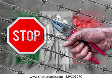 Italy flag, STOP sign, migrants and barb wire with pliers