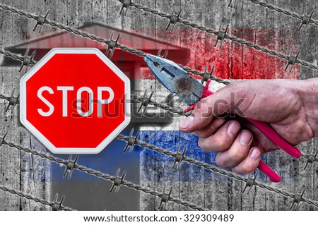 Netherland flag, STOP sign, border house and barb wire with pliers