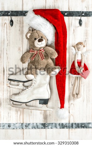 Red Santa's hat, Teddy Bear, angel and white ice skates. Vintage style christmas decoration