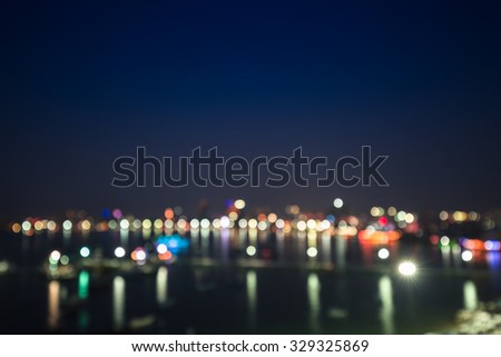Colorful bokeh of city skyline from the sea in night time