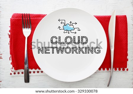 Cloud Networking concept on white plate with fork and knife on red napkins
