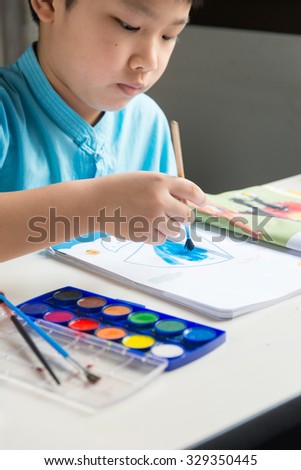 Boy Painting Coloring Book In The Room