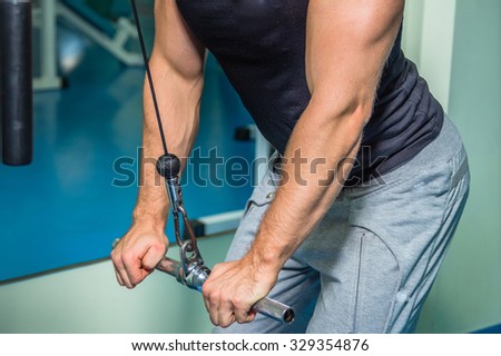 The athlete demonstrates muscles while bench dumbbell. Work on your body and achieve the goal. Photos for sporting magazines and websites. 