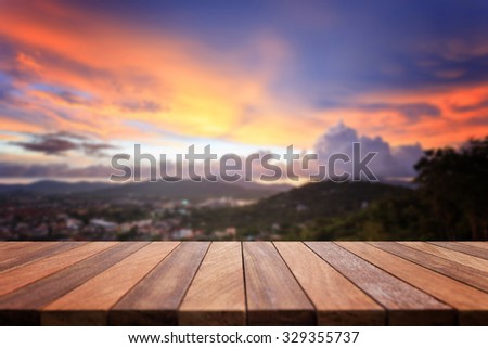 Empty top of wooden table and view of sunset or sunrise background. For product display