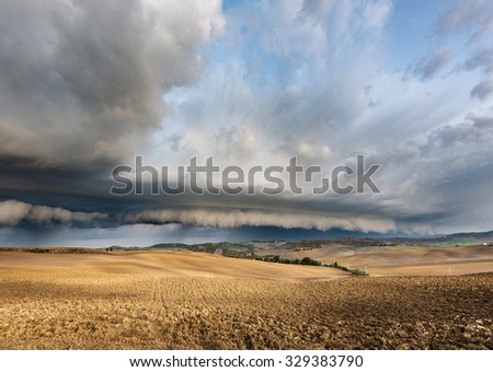 Thunderstorm over the fields in autumn morning