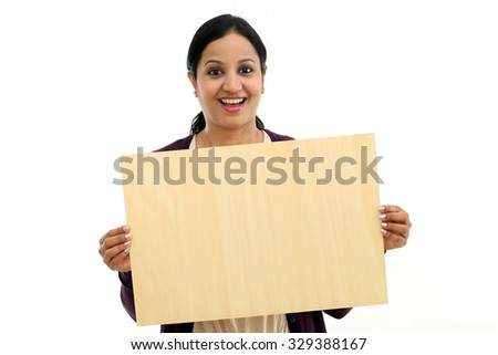 Smiling young Woman holding blank wood sheet