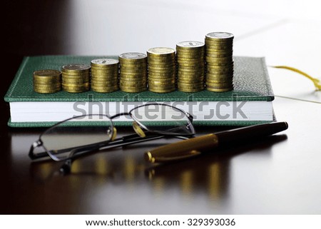 coin exchange rate glasses pen notebook