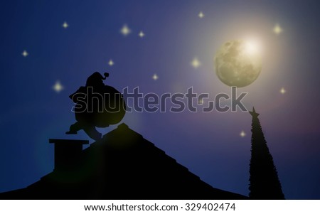 silhouette of Santa going down the chimney on the roof to be handing out gifts to children. cute Christmas greeting, card concept, Christmas day.