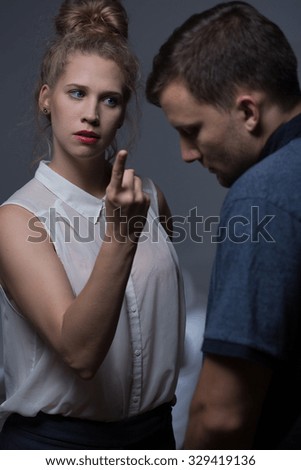  Aggressive woman orders the man and manipulates his behavior Royalty-Free Stock Photo #329419136