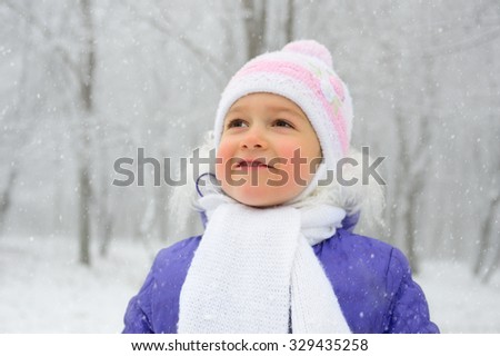 Little girl in the winter forest