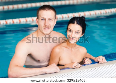 Young couple in the swimming pool, water