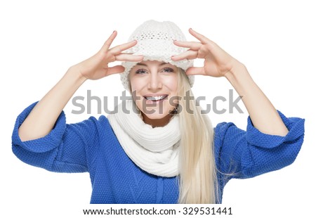 Portrait of beautiful young blonde girl wearing winter clothing studio shot.