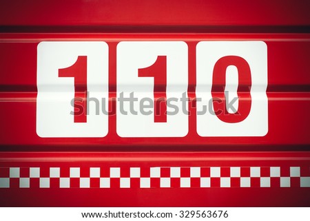 emergency telephone number 110 for fire written on fire truck back side